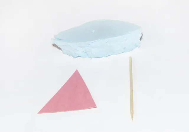 Styrofoam boat, a pink triangle for the sail and a bbq skewer