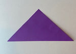 A square paper is folded in half to make a triangle.