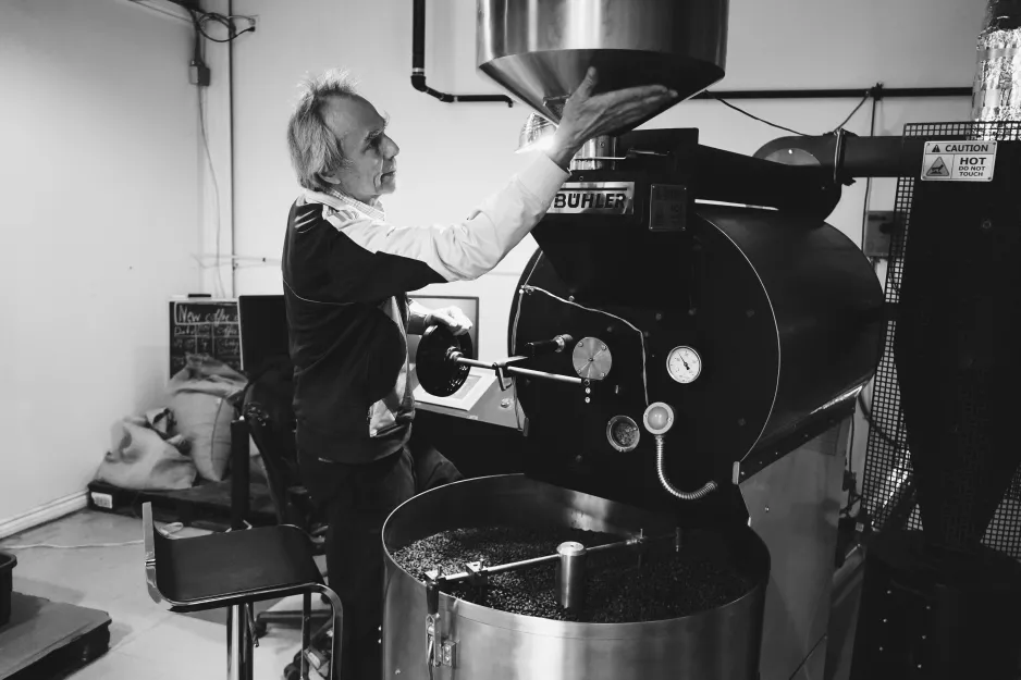 Hans Langenbahn adjusts the coffee roasting equipment.