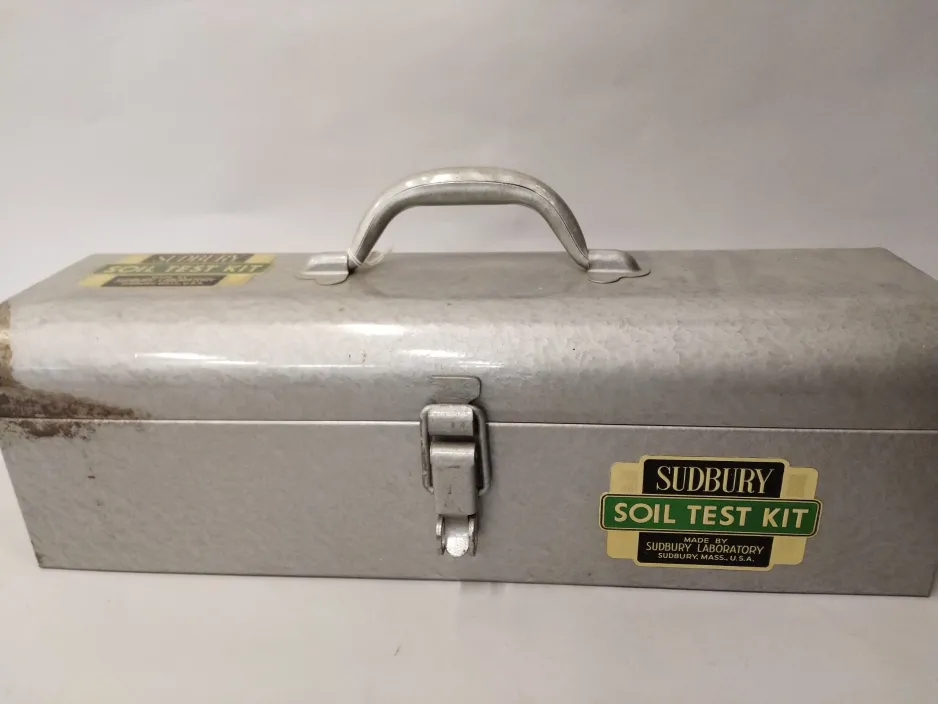 The metal toolbox-like carrier for the soil test kit.
