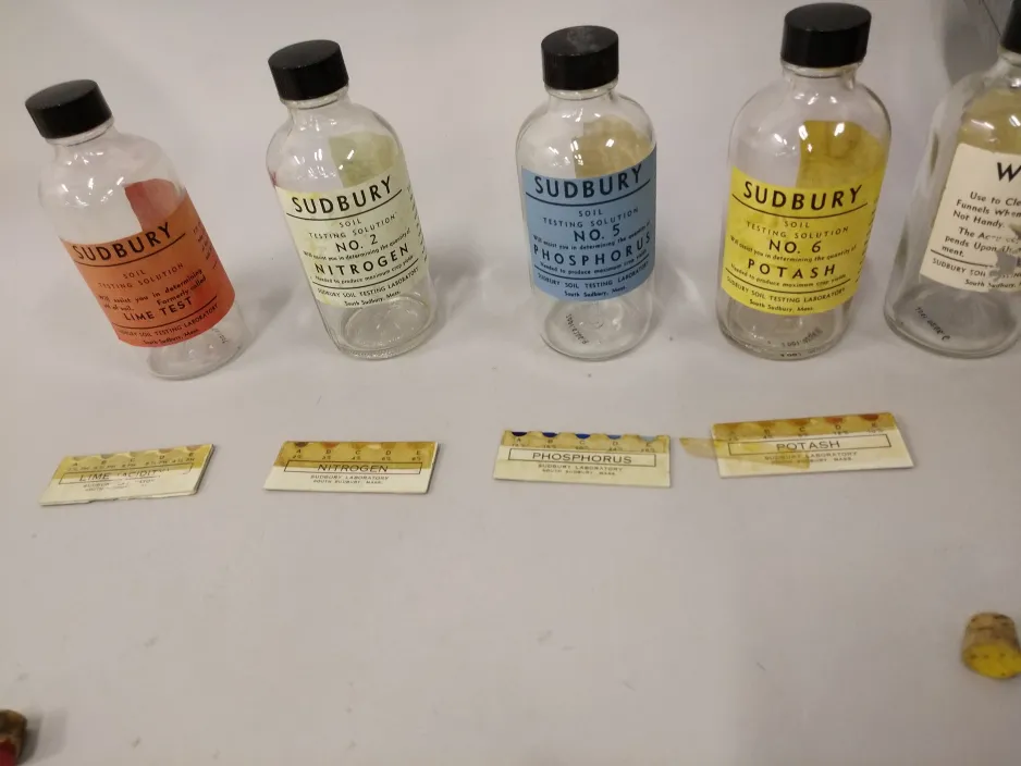 Bottles and the colour-coded strips used to test if the chemical was in the soil, and at what quantity.