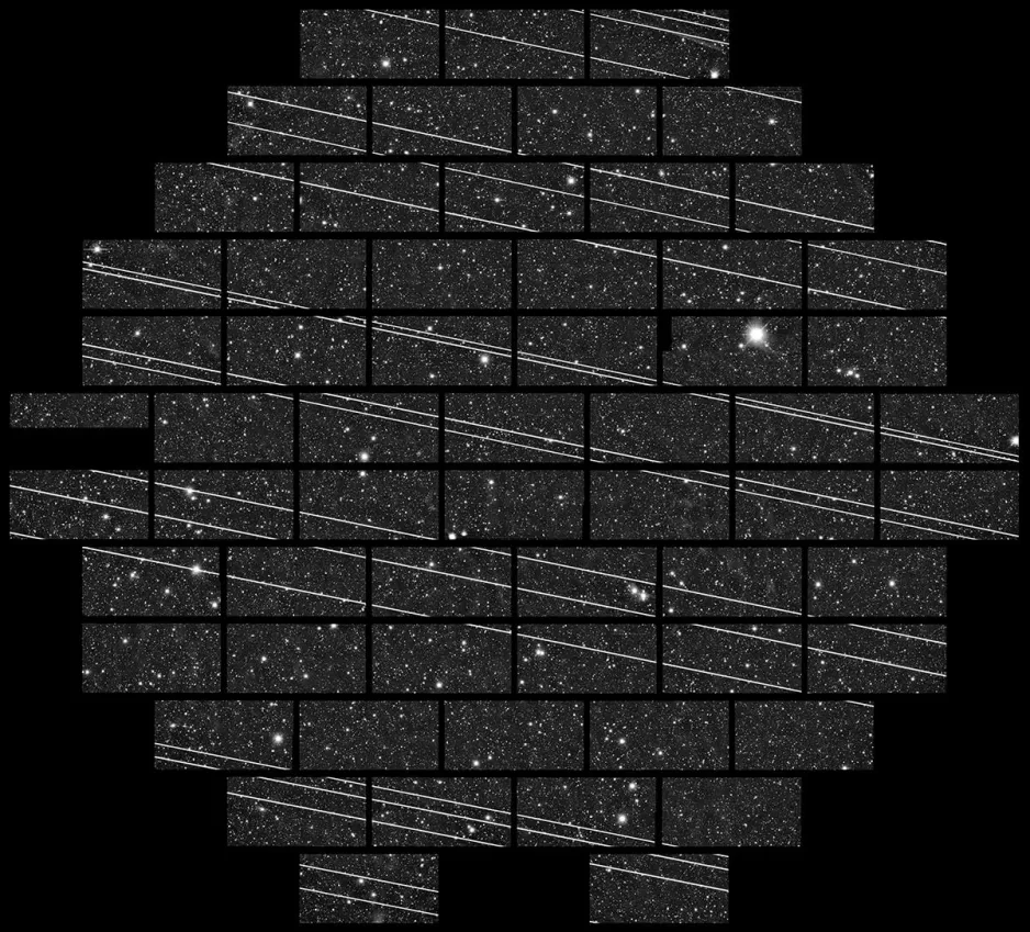 An image of the night sky, with many individual stars visible. There are a large number of white streaks going across the image, created by the Starlink satellites flying through the frame.
