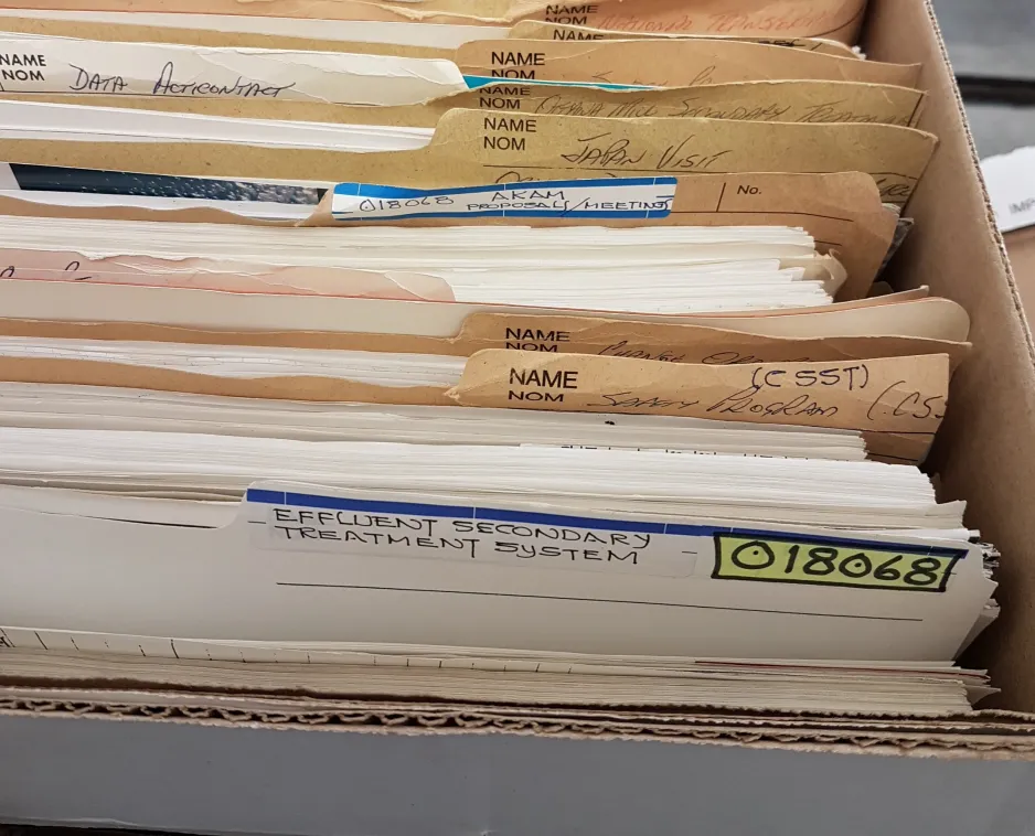 Colour photograph showing file folders in an open box with their titles showing.  