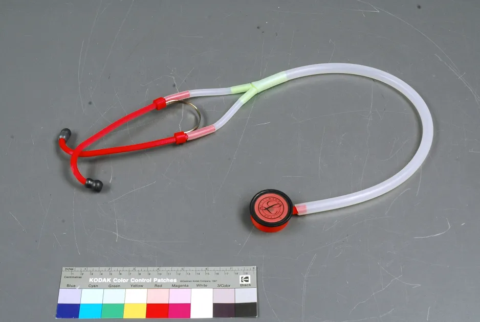 3D-printed modern binaural stethoscope with components made of vibrant red and white plastics.