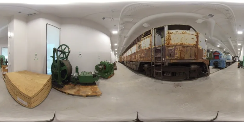 A 360 panoramic image of a large and rusted locomotive.  