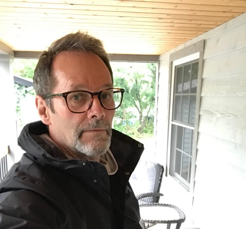 Portrait of William Knight taken as a selfie on a porch