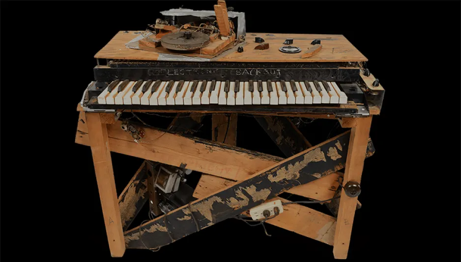 Front-facing view of the of the Electronic Sackbut synthesizer including its wooden support structure, keyboard, and surface controls.