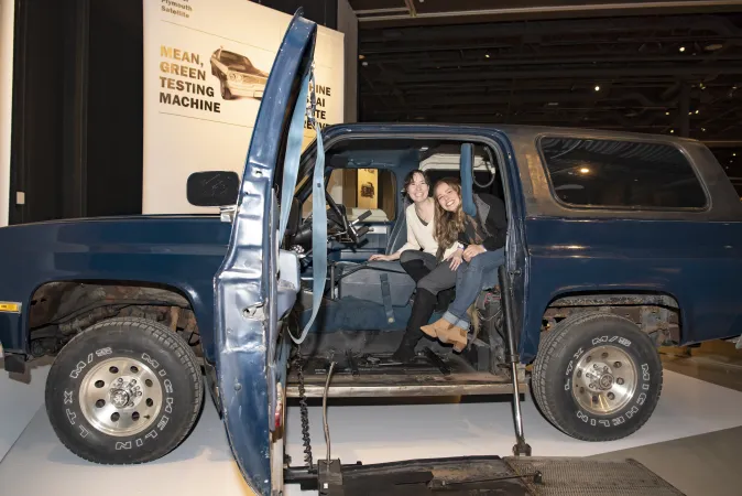 Elaine’s daughters, Jamie Wolfe Phillips and Emily Wolfe Phillips, get a chance to sit in their childhood vehicle, which is now part of the Moving Stories exhibition.