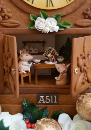 Tiny mice, made of sugar, sit inside the gingerbread clock.