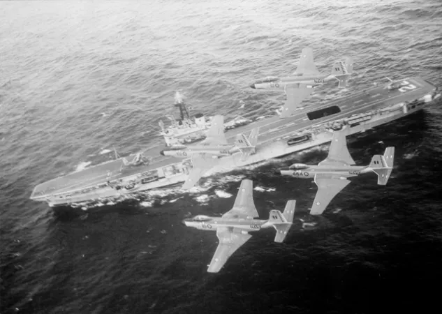 2 McDonnell F2H-3 Banshee flying over an aircraft carrier