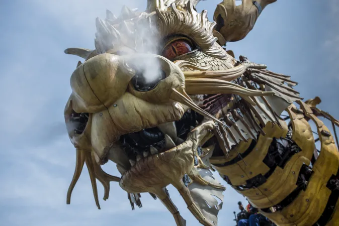 A building-sized mechanical dragon with steam coming from its nostrils.