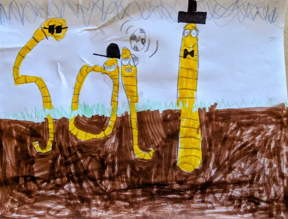 A drawing of four earthworm characters coming out of the dirt. Their bodies are drawn so they form the word soil.