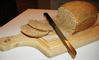 a knife slicing a loaf of bread