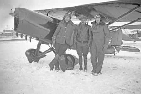 Three pilots posing with a Curtiss JN-4D Jenny aircraft at Cartierville
