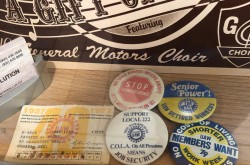 This photograph shows an assortment of Unifor Local 222 ephemera. It includes Patrick J. Brown’s 1937 United Autoworkers of America Local 222 union membership card and an assortment of union buttons from the 1970s to the 1980s that advocate for increased job security, shorter work weeks, and the rights of retired General Motors employees.